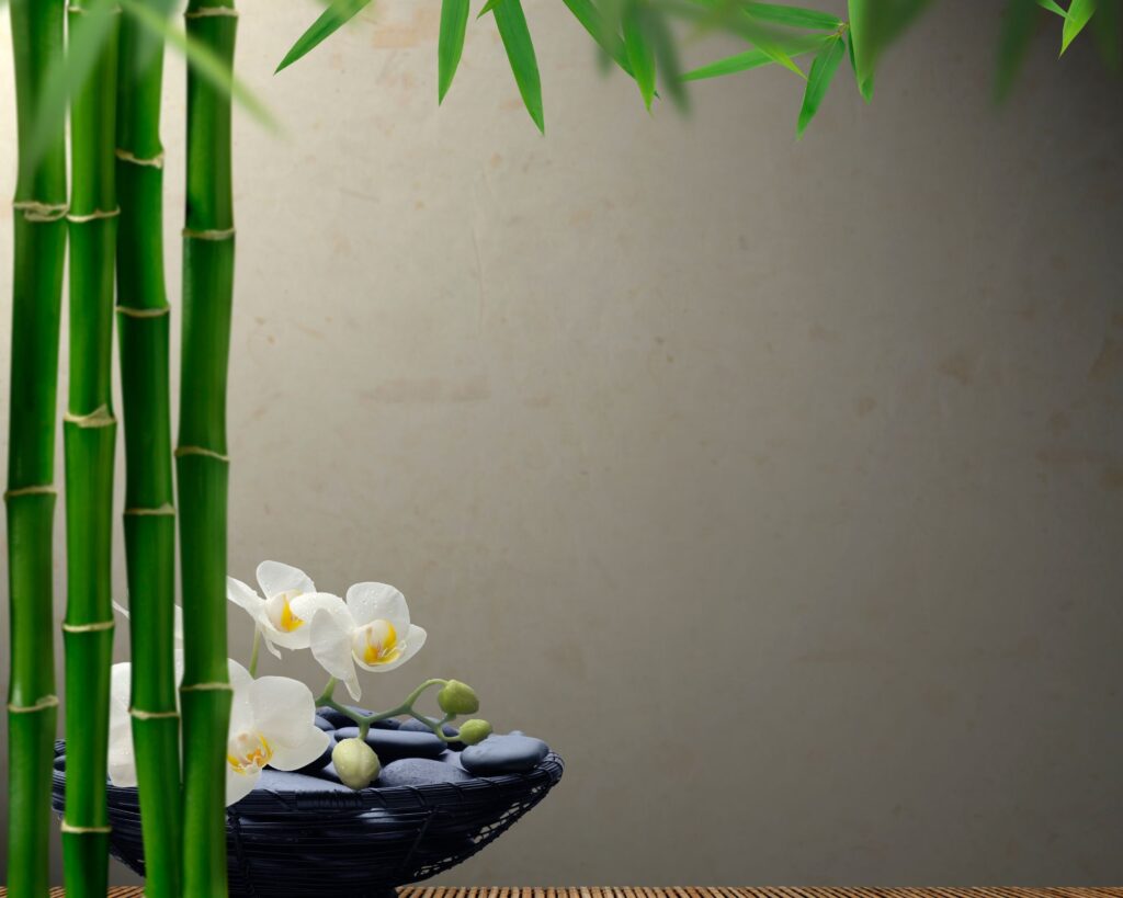 An image depicting a serene setting for bamboo massage therapy, with warm bamboo sticks arranged alongside aromatic candles, inviting a sense of tranquility and rejuvenation.