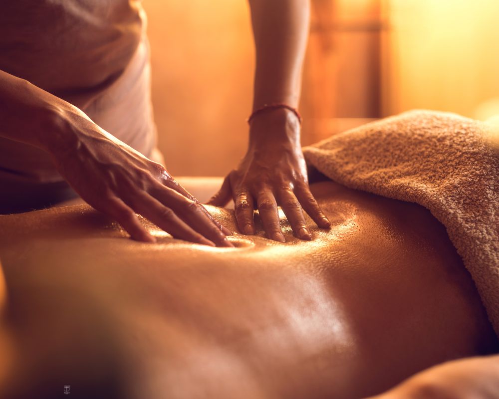 Client receiving a Thai massage in a serene spa setting.
