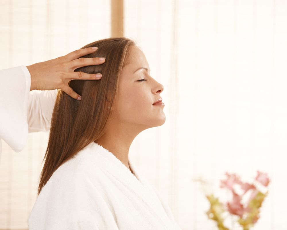 Expert hands performing precise Indian head massage, illustrating neurological stress reduction methods