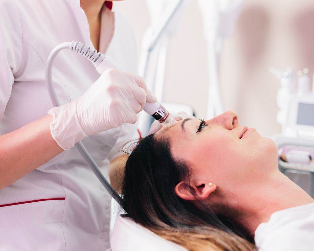 Client receiving a relaxing HydraFacial session in a professional spa clinic.